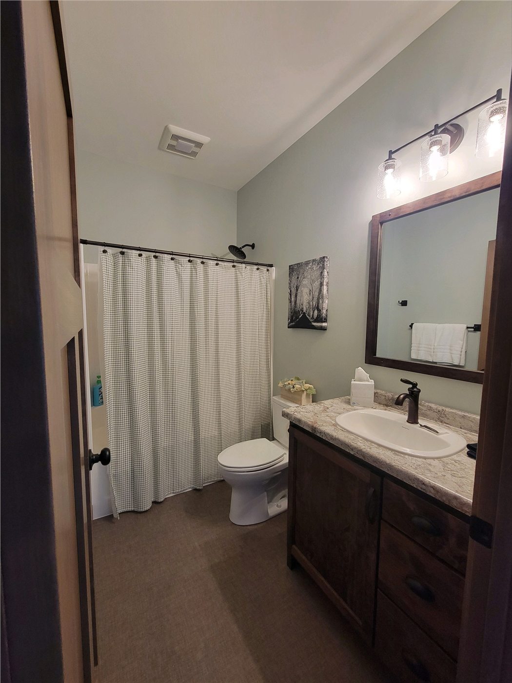 Main bathroom with vanity, tub, and shower