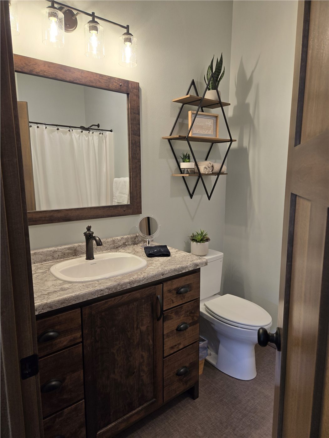 Vanity and mirror in the private primary bathroom